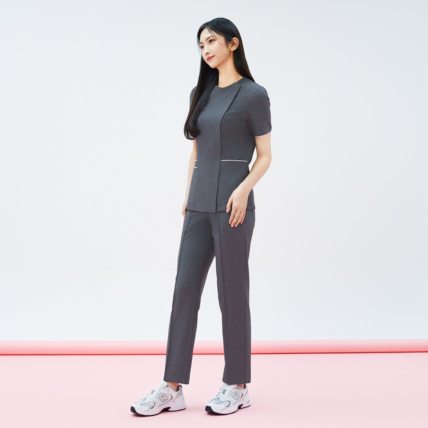Full-length shot of TUL Women's Premium Banding Pants in Chacoal Gray, paired with a matching scrub top for a cohesive, professional look.