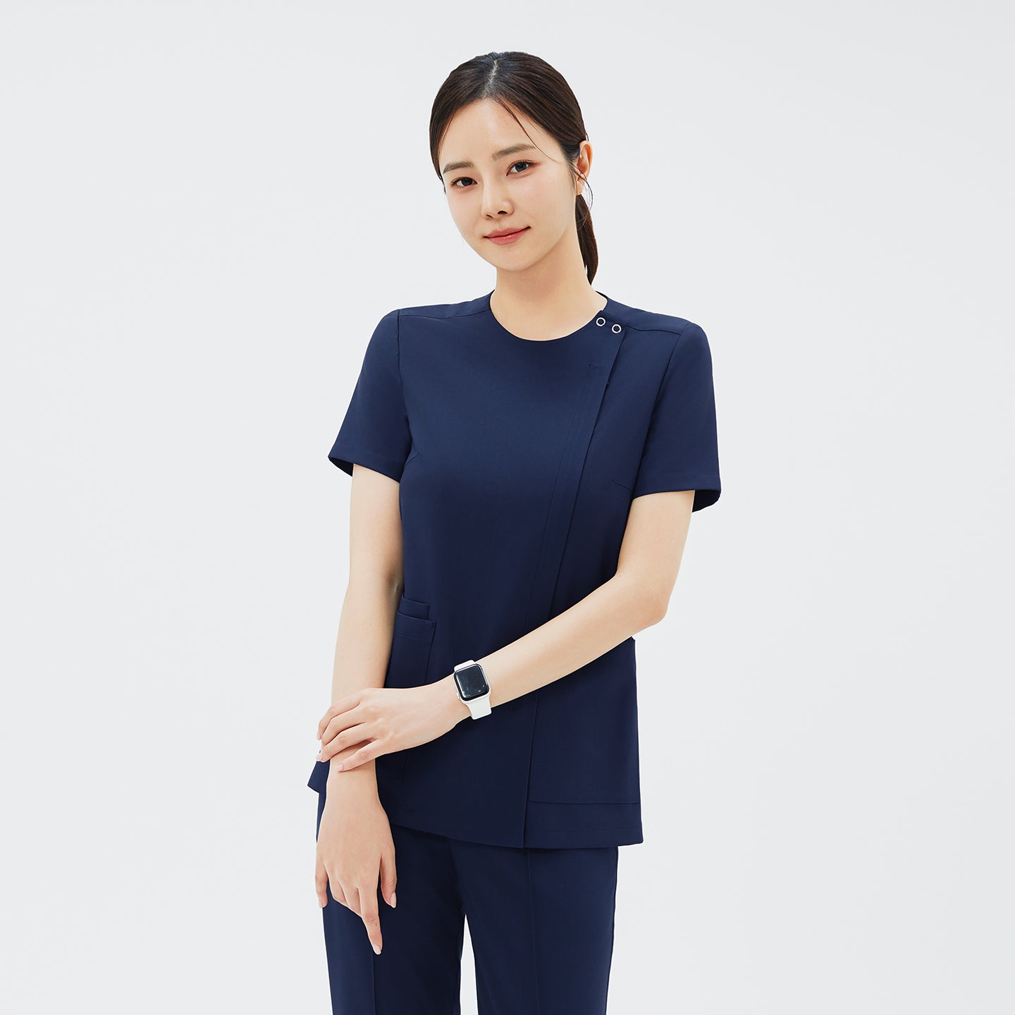 Image of Front view of TUL OS-213 Women's Dual Snap Front Zipper Scrub Top in Classic Navy, emphasizing the tailored fit and two spacious pockets.