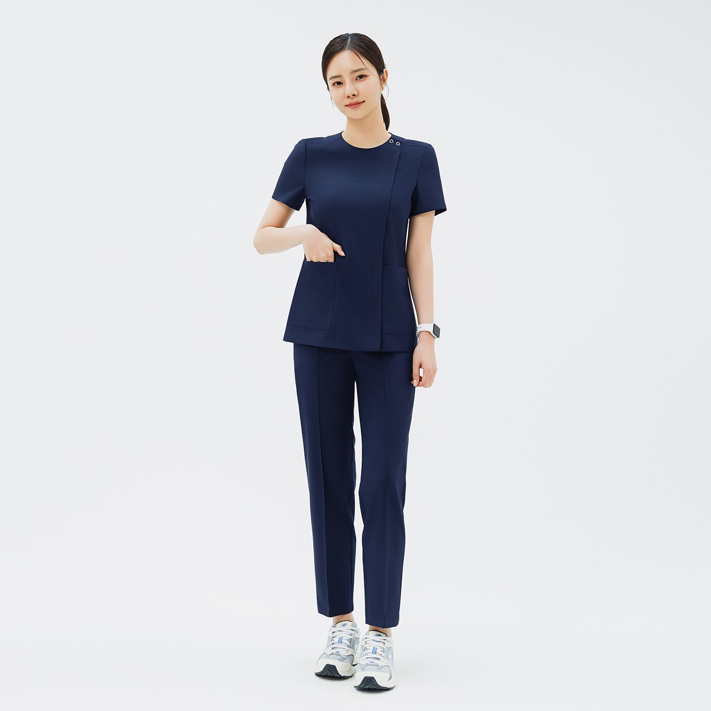 Full-length shot of TUL OS-213 Women's Dual Snap Front Zipper Scrub Top in Classic Navy, paired with matching pants for a cohesive uniform.
