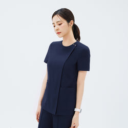 Image of Side angle of TUL OS-213 Classic Navy scrub top, highlighting the discreet front zipper closure and short sleeves.