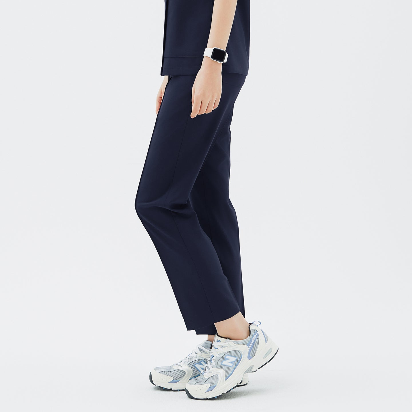 Side angle of TUL Women's Premium Banding Pants in Classic Navy, showing sleek seam details and stretch fabric for easy movement.