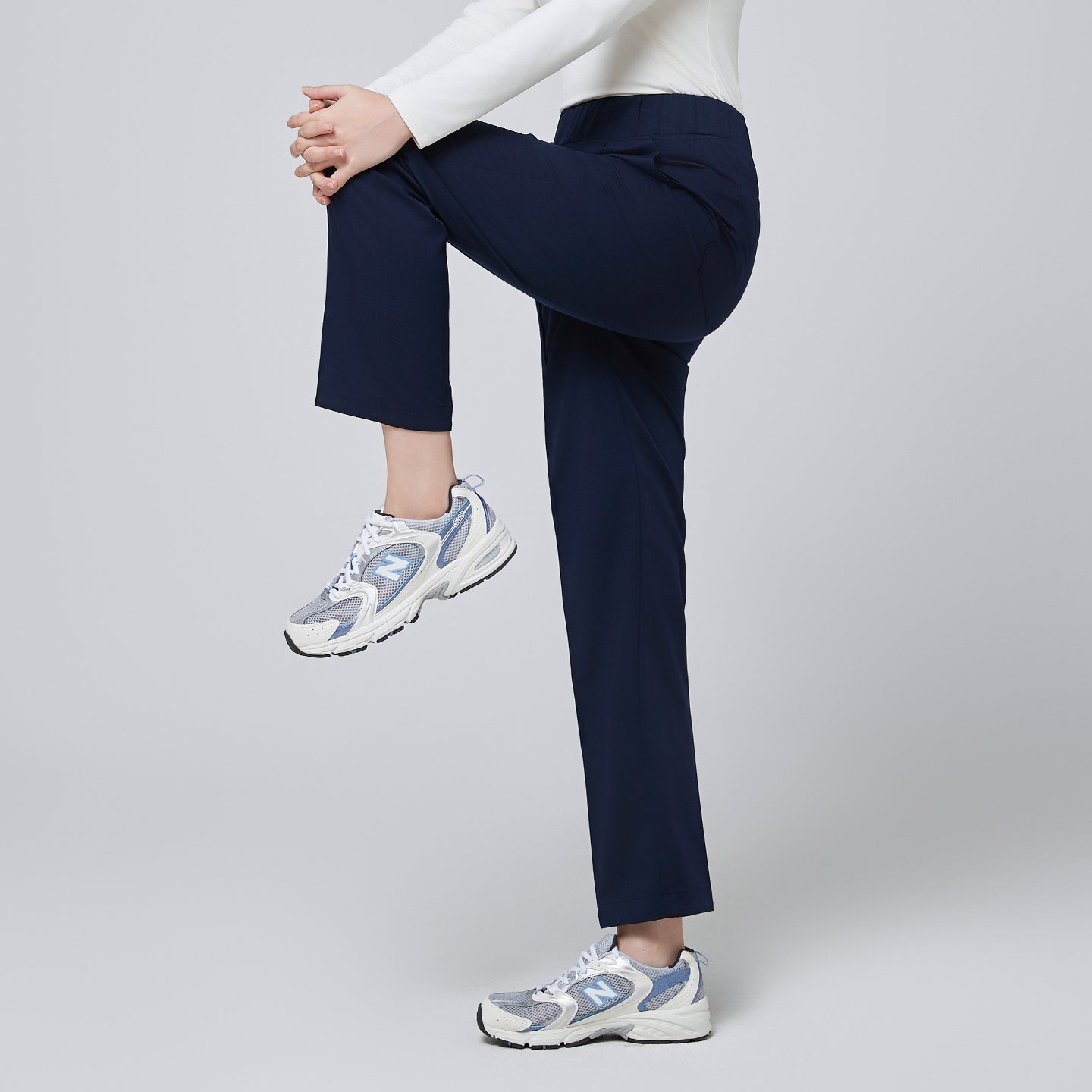 Image of Side angle of TUL Women's Premium Banding Pants in Classic Navy, showing sleek seam details and stretch fabric for easy movement.