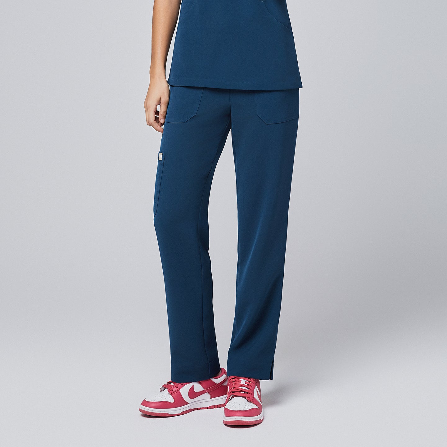 Image of Dark Blue Split Hem Scrub Pants featuring a straight relaxed fit with subtle ankle slit.