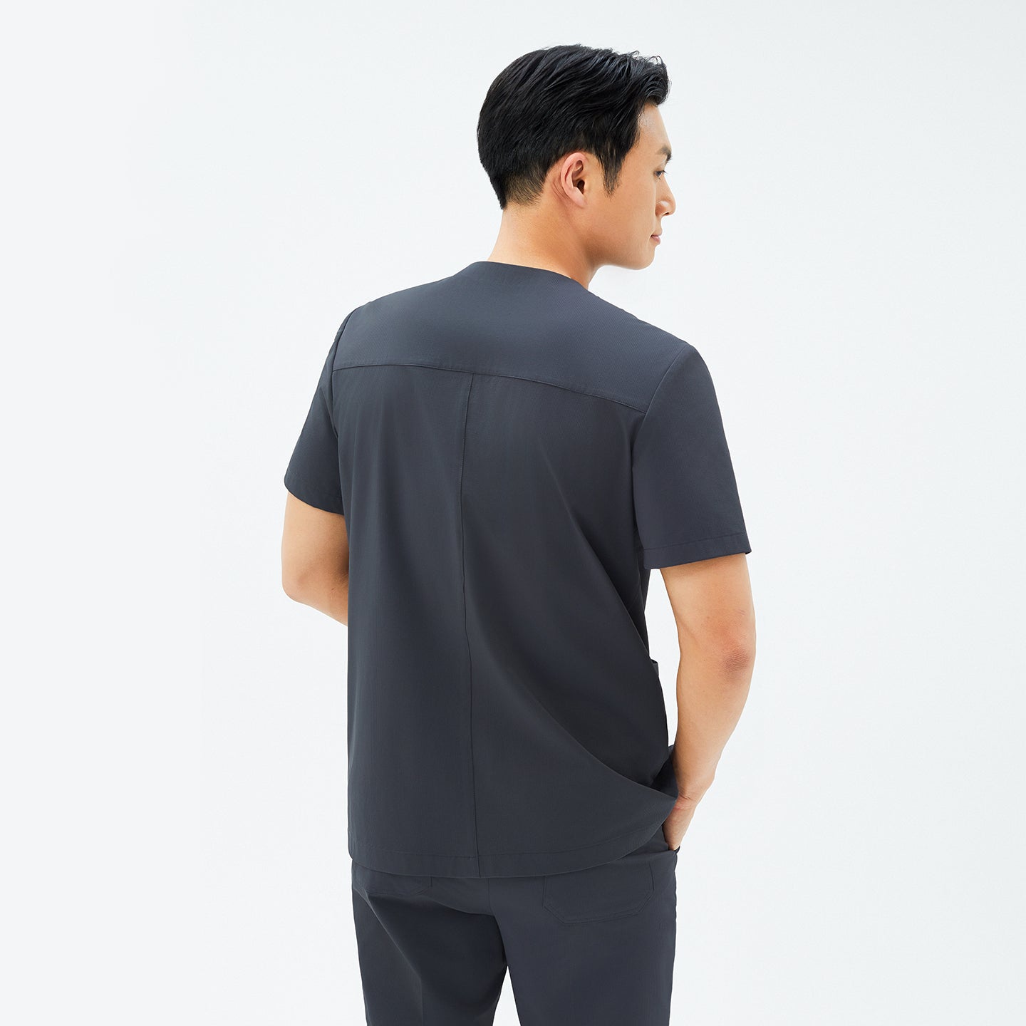 Back view of TUL DS-186 Men’s V-Snap Zipper Scrub Top in Deep Gray, emphasizing structured seams and a comfortable silhouette.
