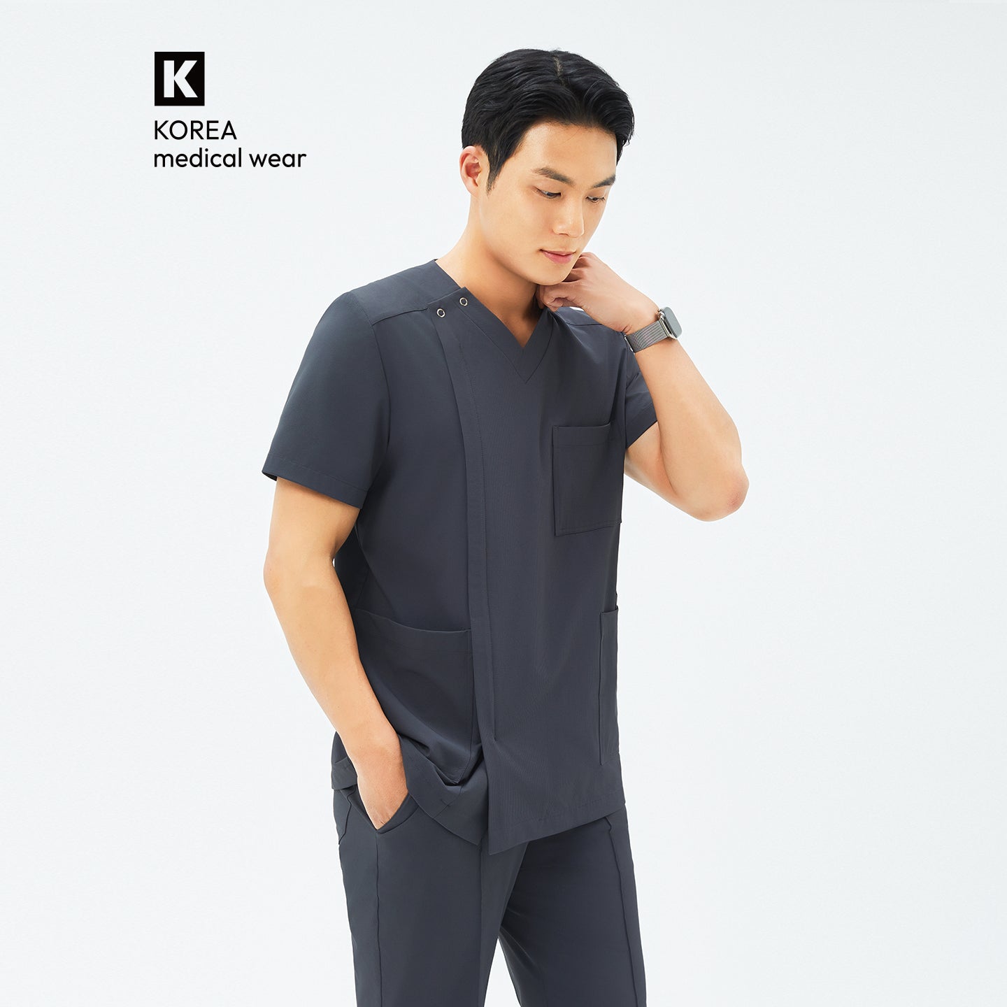 Image of Side angle of TUL DS-186 Deep Gray scrub top, highlighting a tailored fit and durable fabric construction.