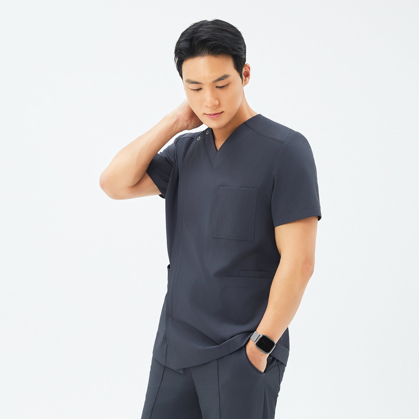 Image of Side angle of TUL DS-186 Deep Gray scrub top, highlighting a tailored fit and durable fabric construction.
