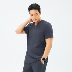 Image of Side angle of TUL DS-186 Deep Gray scrub top, highlighting a tailored fit and durable fabric construction.