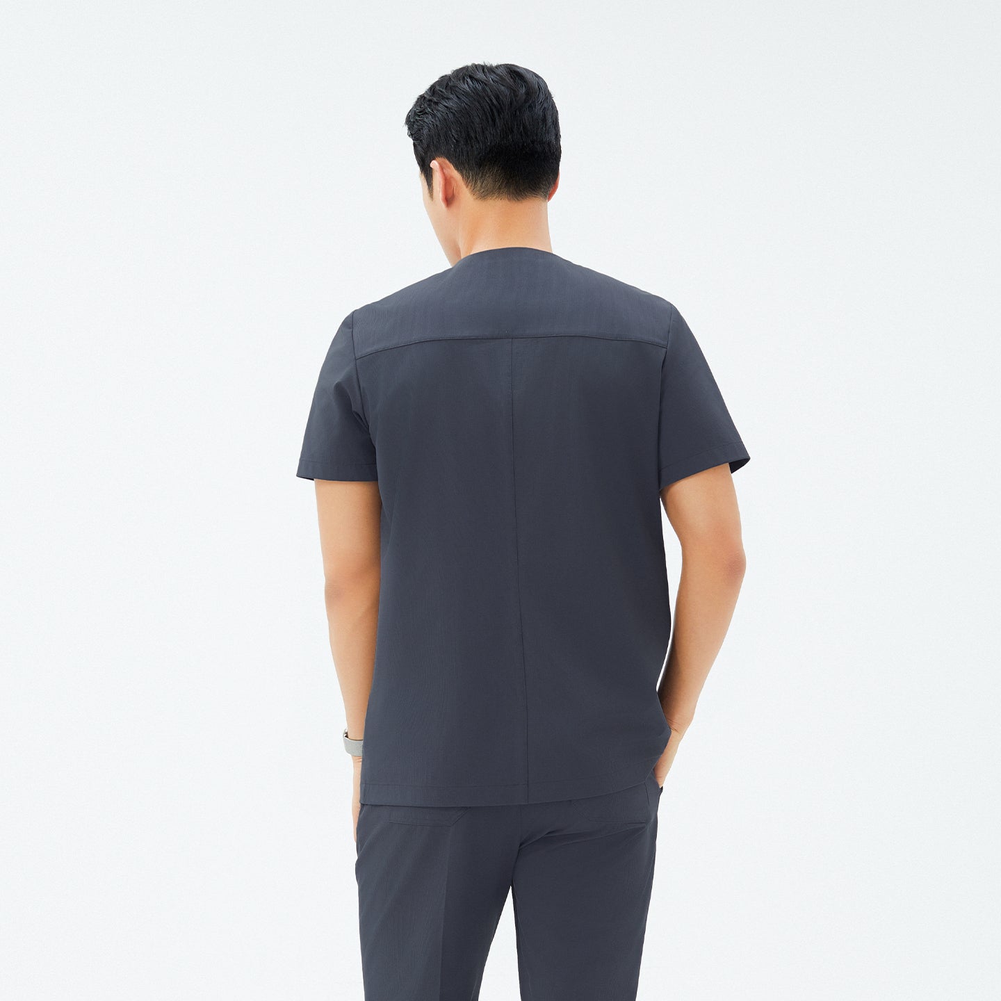 Back view of TUL DS-189 Men's Deep Gray scrub top, highlighting structured seams and a clean, modern silhouette.