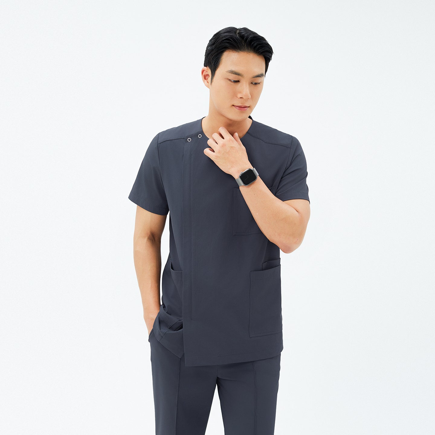 Model wearing TUL DS-189 Men's Deep Gray scrub top, paired with matching pants for a cohesive, professional uniform.