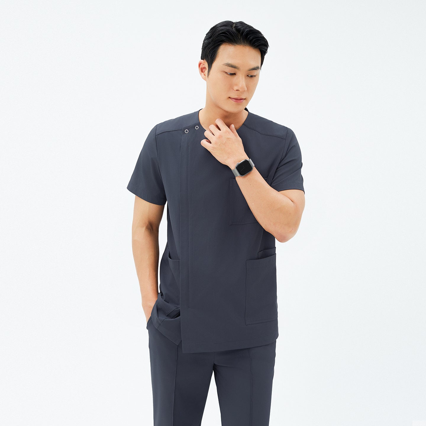 Image of Model wearing TUL DS-189 Men's Deep Gray scrub top, paired with matching pants for a cohesive, professional uniform.