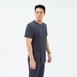 Image of Side angle of TUL DS-189 Deep Gray scrub top, featuring a round snap collar, front zipper closure, and spacious front pockets.