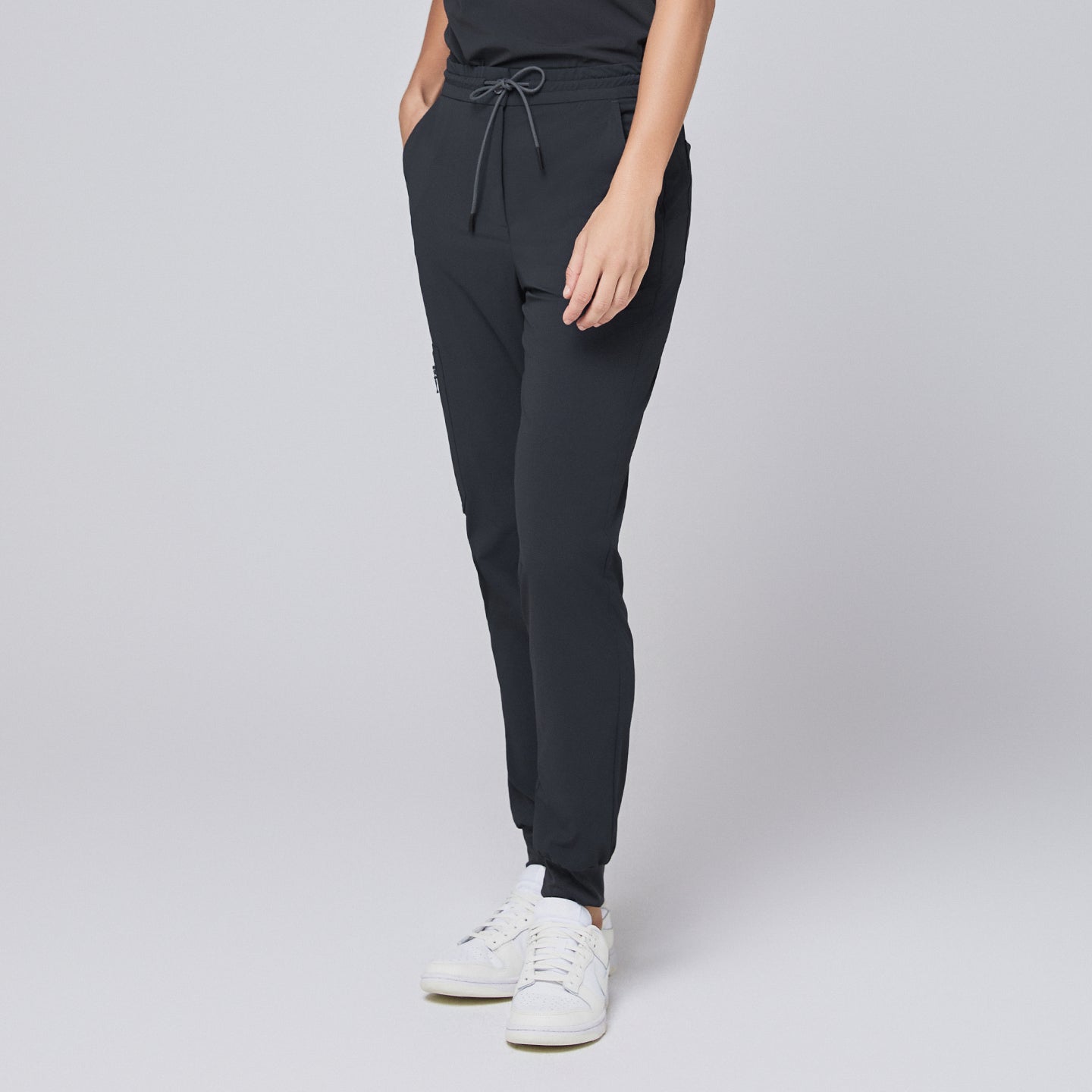 Image of Deep gray jogger scrub pants with drawstring waistband and elastic cuffs, paired with white sneakers,Deep Gray