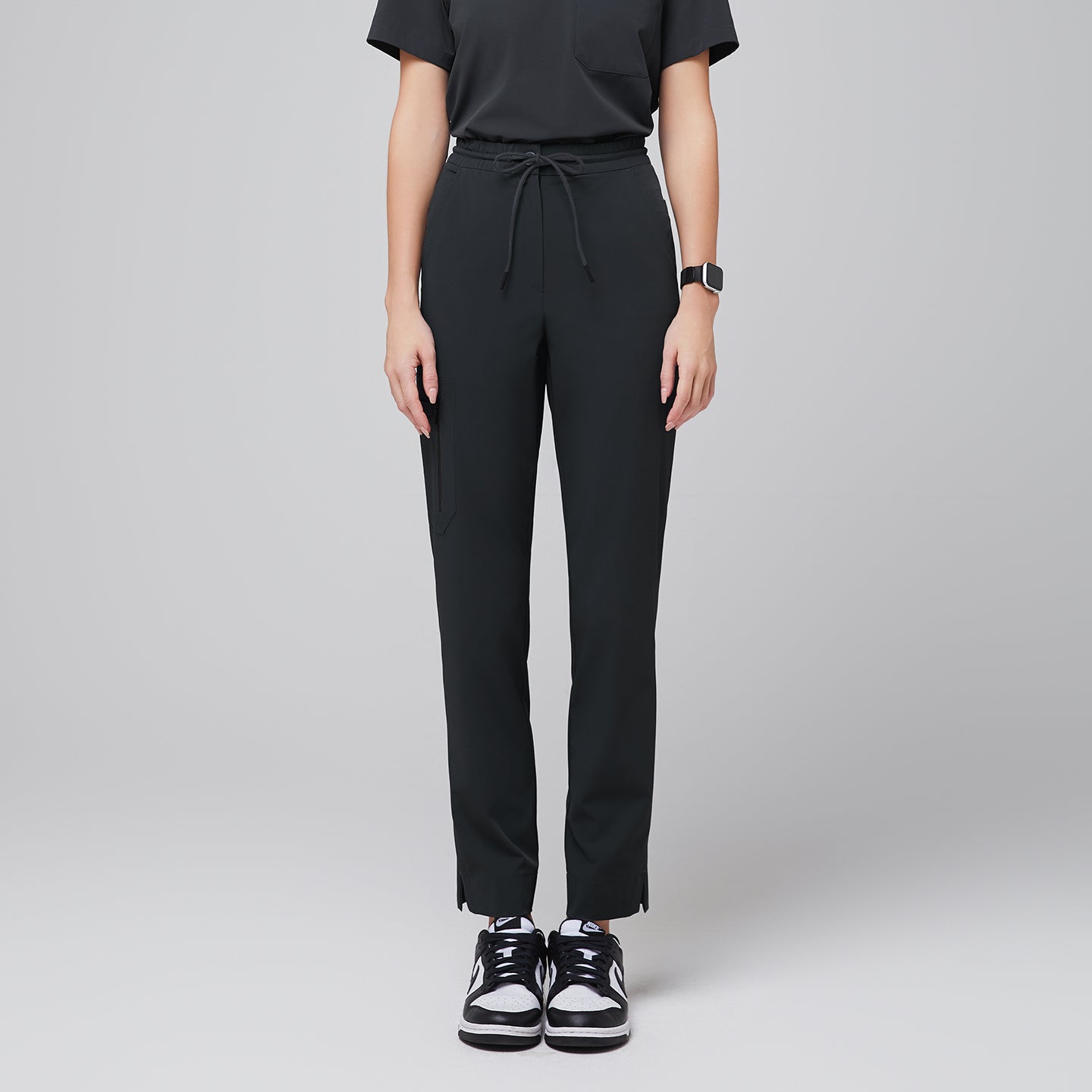 Image of Scrub pants with a drawstring waist, zipper pockets, and split hem, paired with a short-sleeve top and sneakers for a functional and stylish uniform,Deep Gray
