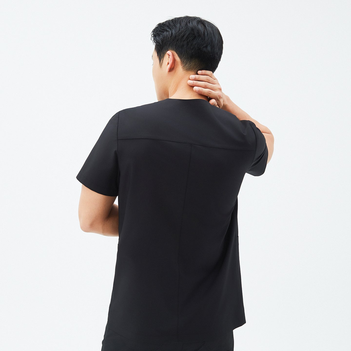 Back view of TUL DS-184 Men's V-Snap Zipper Scrub Top in Eco Black, emphasizing structured seams and durable fabric.