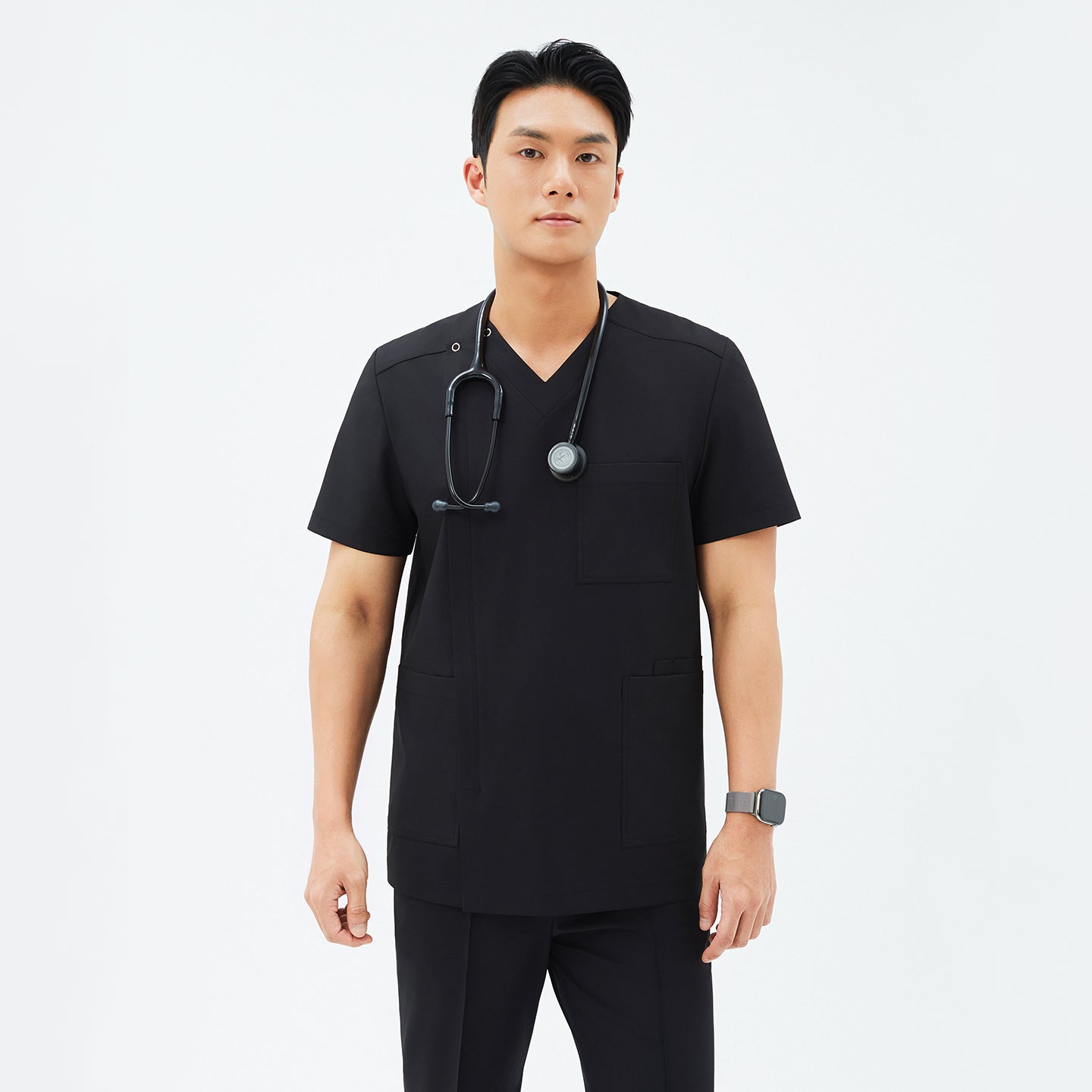 Model wearing TUL DS-184 Men's Eco Black scrub top, paired with matching scrub pants for a cohesive professional uniform.