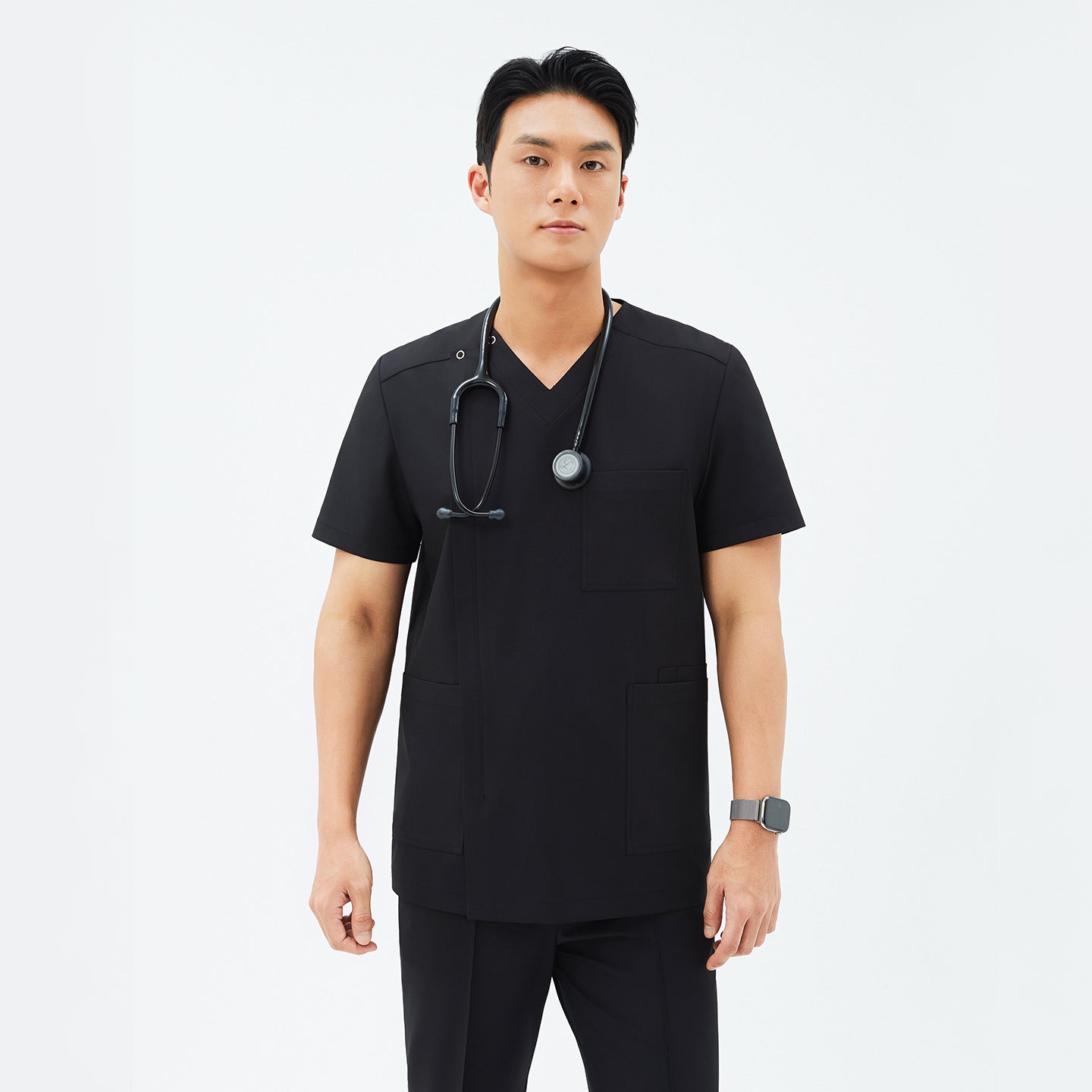 Image of Model wearing TUL DS-184 Men's Eco Black scrub top, paired with matching scrub pants for a cohesive professional uniform.