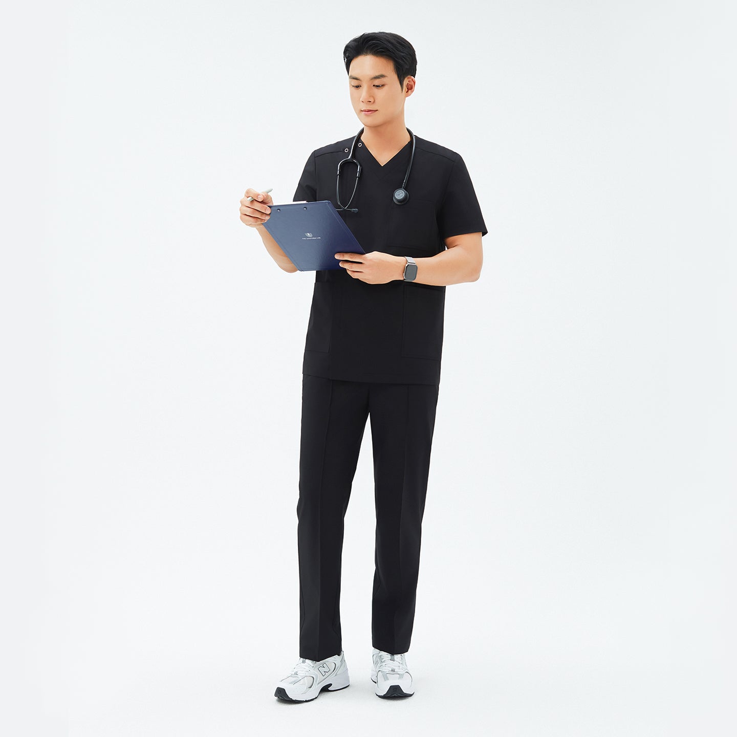 Image of Full-length shot of TUL DS-184 Men's V-Snap Zipper Scrub Top in Eco Black, showcasing a modern V-snap neckline and front zipper.