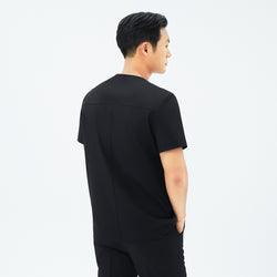 Image of Back view of TUL DS-187 Men's Round Snap Zipper Scrub Top in Eco Black, emphasizing structured seams and a comfortable silhouette.
