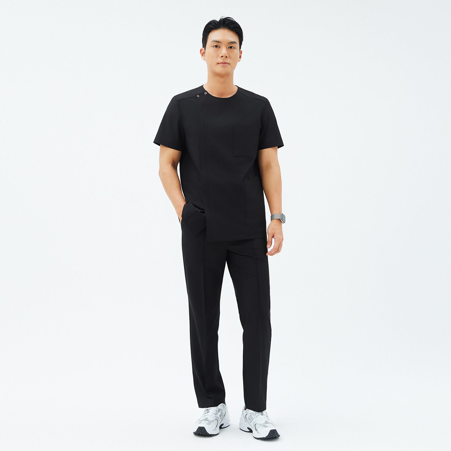 Full-length view of TUL DS-187 Men's Round Snap Zipper Scrub Top in Eco Black, paired with matching pants for a cohesive, professional look.