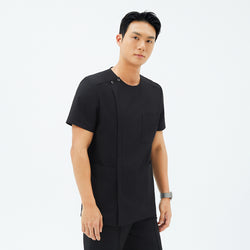 Image of Model wearing TUL DS-187 Men's Round Snap Zipper Scrub Top in Eco Black, featuring a snap collar detail and a sleek front zipper.