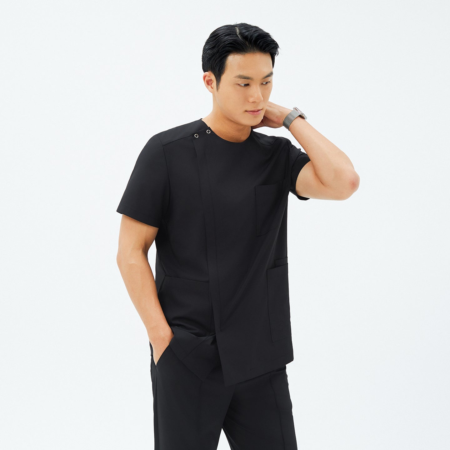 Image of Model wearing TUL DS-187 Men's Eco Black scrub top, paired with matching pants for a cohesive, professional uniform.