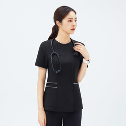Image of Close-up of TUL OS-206 Eco Black scrub top with contrasting edge stripes on sleeves and waist, worn by a medical professional.