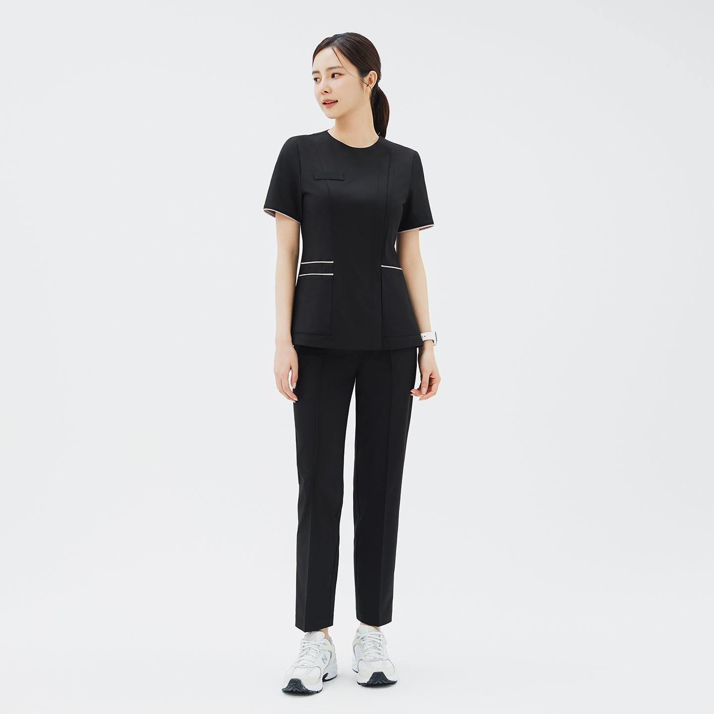 Full outfit featuring TUL OS-206 Eco Black scrub top and matching pants, emphasizing a streamlined and professional look.