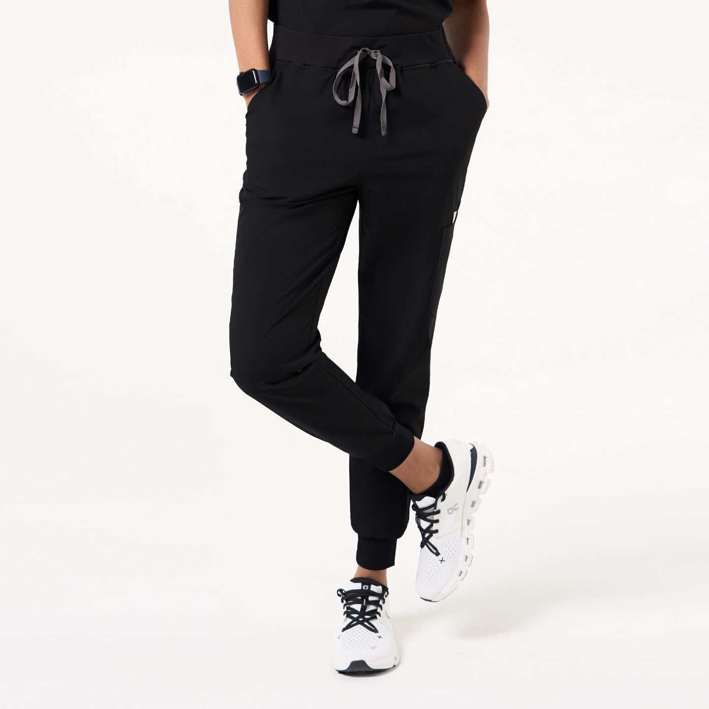 Image of Side view of Eco-Black jogger scrub pants, highlighting the functional cargo pocket and fitted cuffed hem.