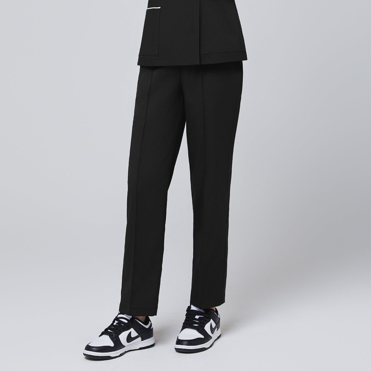 Side angle of TUL Women's Premium Banding Pants in Eco Black, highlighting the straight-leg design and durable stretch fabric.