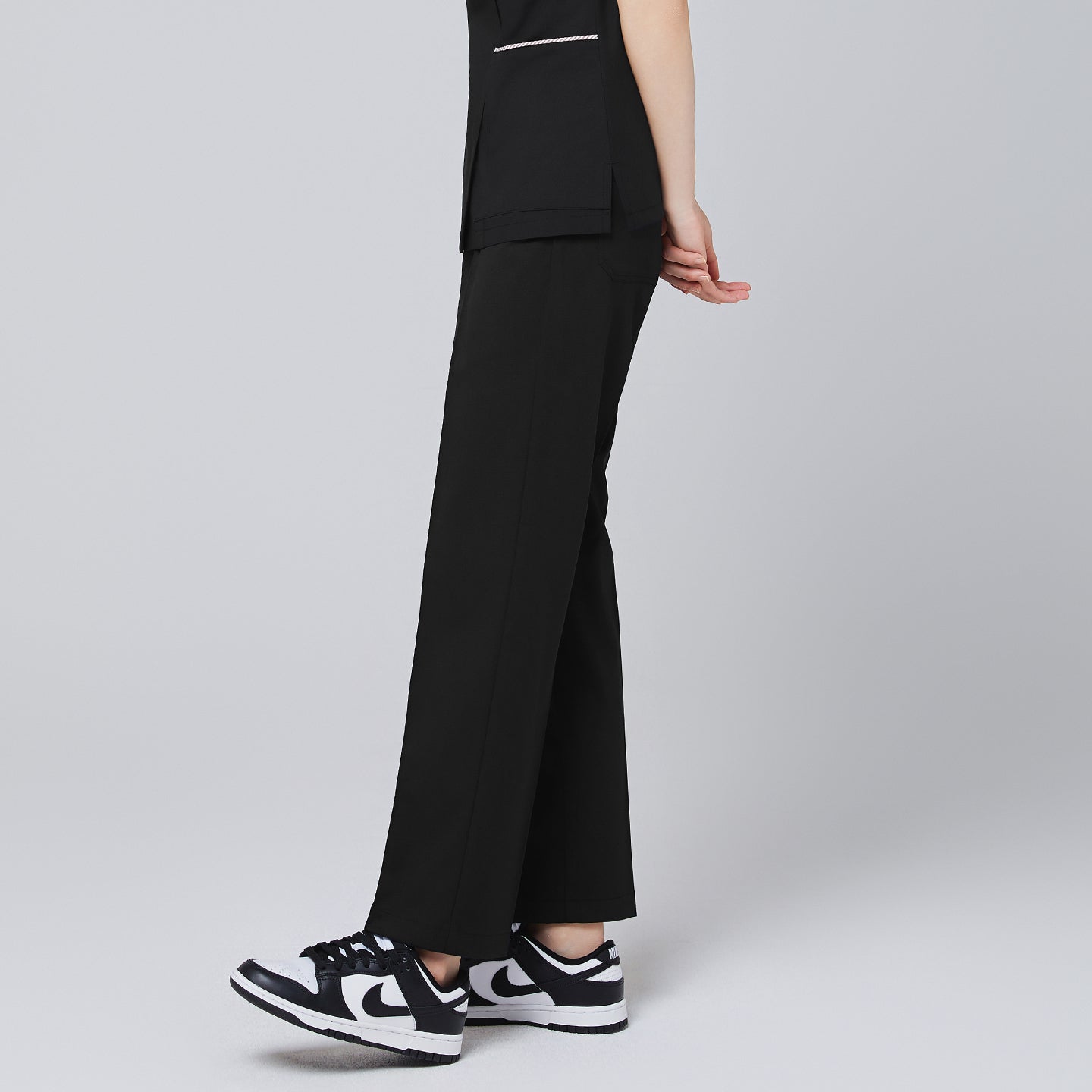 Model walking in TUL Women's Premium Banding Pants in Eco Black, emphasizing the polished seams and relaxed, professional fit.