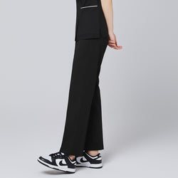 Image of Model walking in TUL Women's Premium Banding Pants in Eco Black, emphasizing the polished seams and relaxed, professional fit.