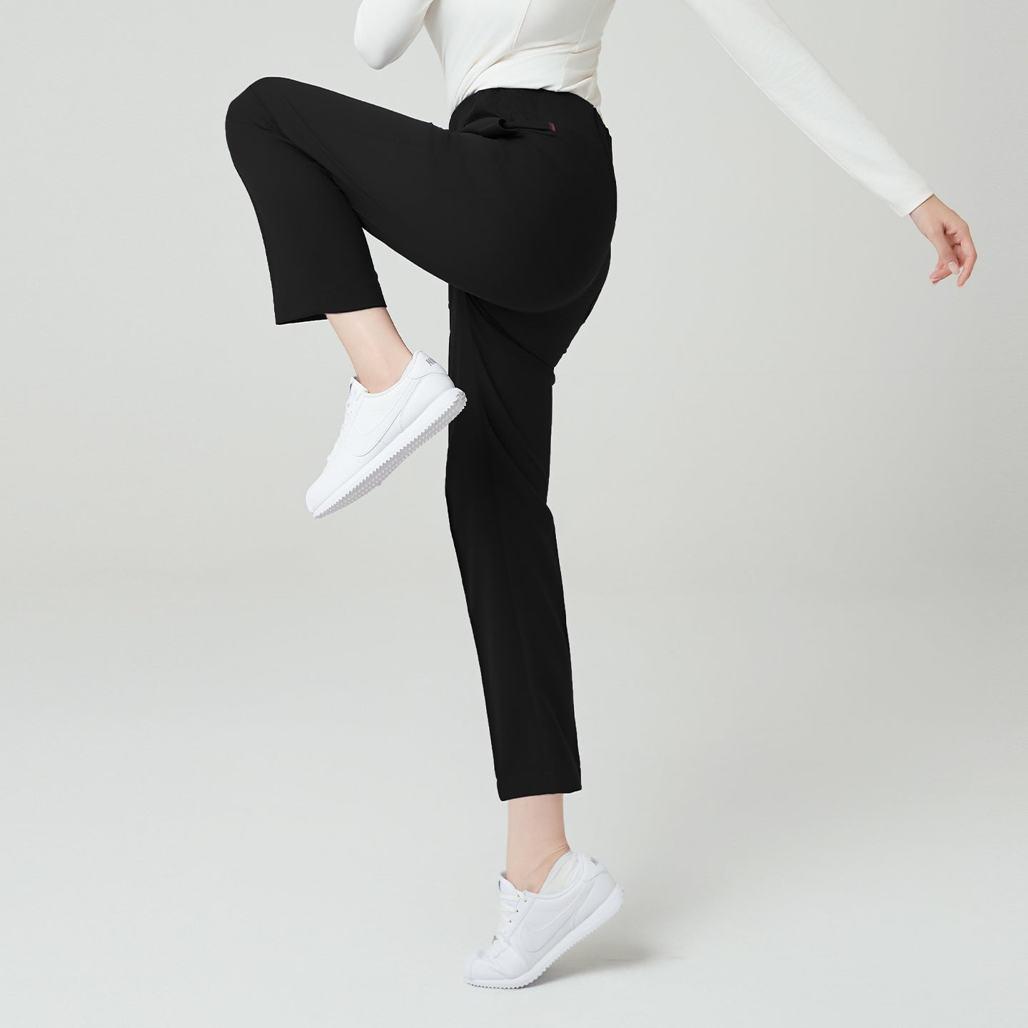 Eco Black Women’s Premium Banding Pants side view, showing high-rise elastic waistband and flexible straight-leg design that allows easy movement.