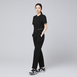 Image of Full-length shot of TUL Women's Premium Banding Pants in Eco Black, paired with a matching scrub top for a cohesive uniform.