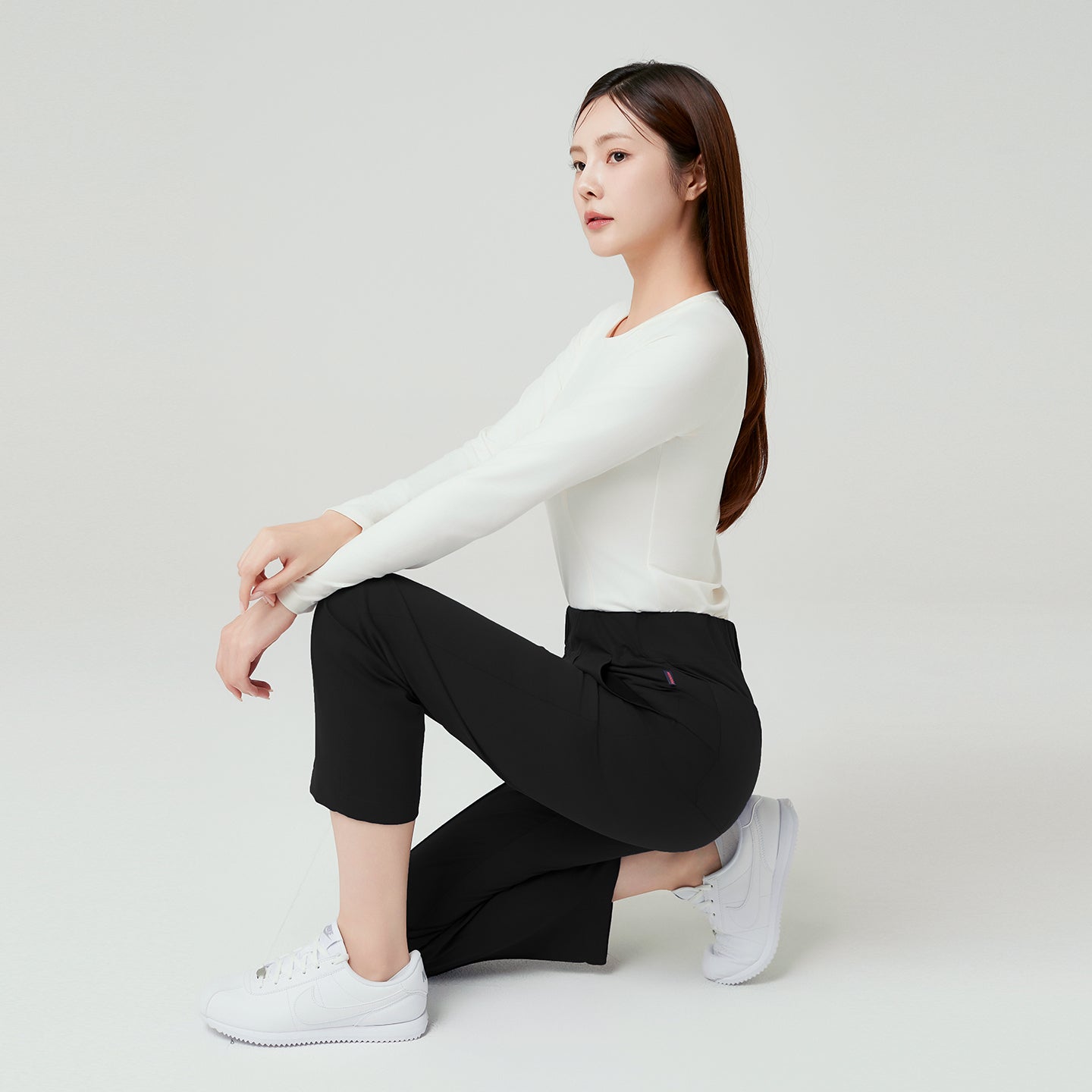 Eco Black Women’s Premium Banding Pants in motion, showcasing flexible stretch fabric and sleek straight-leg design with a comfortable high-rise waistband.