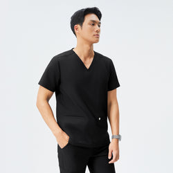 Image of Man in black scrubs with a V-neck and double pockets, checking the time on his smartwatch,Eco Black