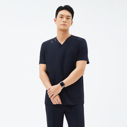Image of Model wearing TUL DS-185 Men's Eco Navy scrub top, emphasizing the V-neck design, front pockets, and a comfortable fit.