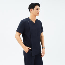 Image of Side angle of TUL DS-185 Men's V-Snap Zipper Scrub Top in Eco Navy, featuring a V-neck with snap details and a spacious front pocket.