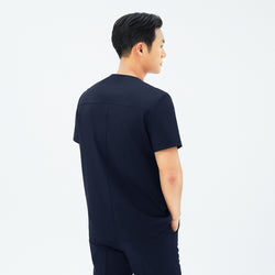 Image of Back view of TUL DS-188 Men's Round Snap Zipper Scrub Top in Eco Navy, emphasizing structured seams and a comfortable silhouette.