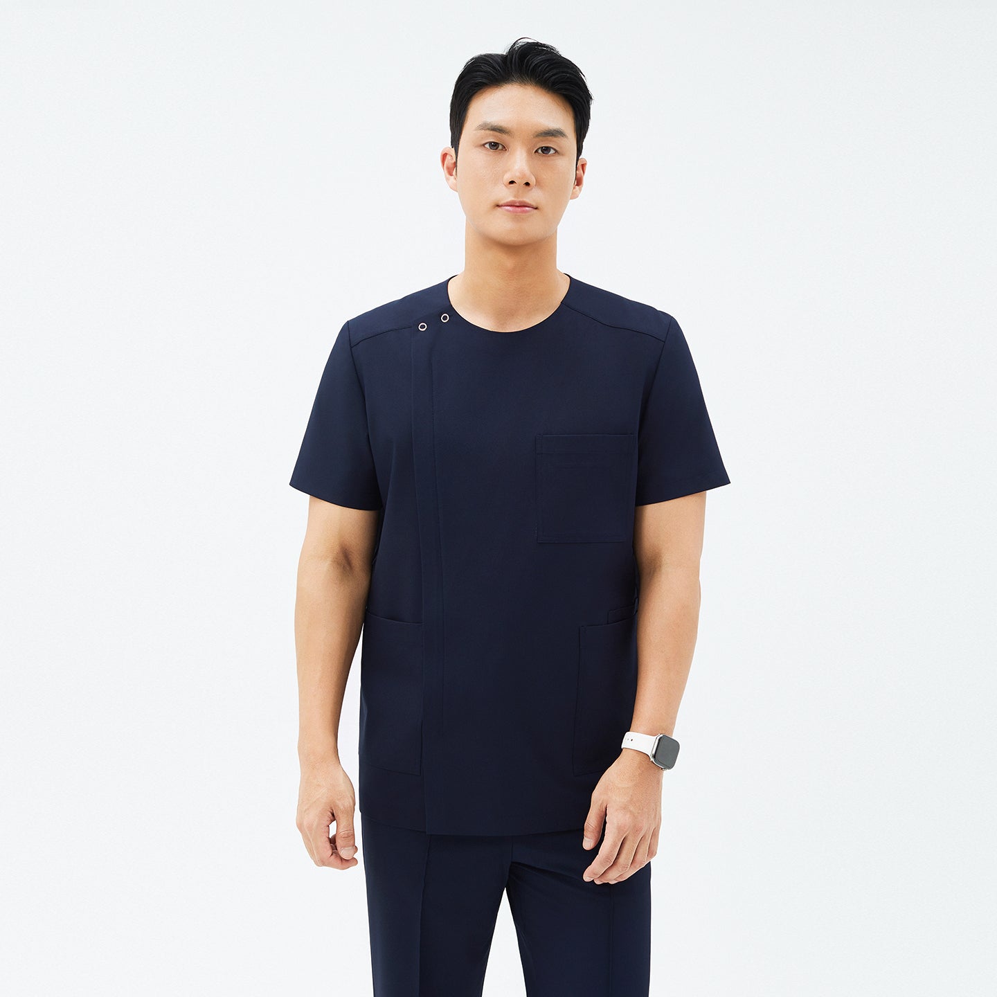 Image of Model wearing TUL DS-188 Men's Eco Navy scrub top, paired with matching pants for a cohesive, professional uniform.
