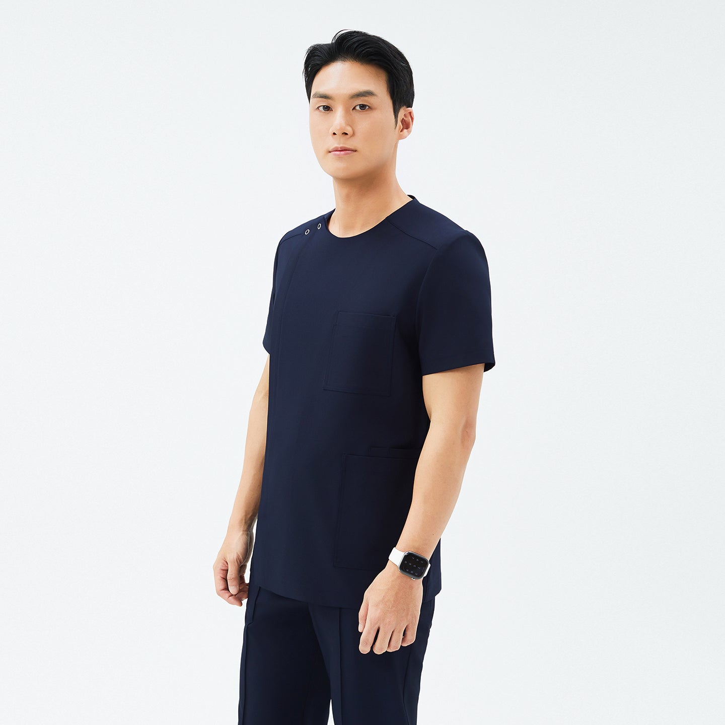Side angle of TUL DS-188 Eco Navy scrub top, highlighting the round snap neckline, tailored fit, and eco-friendly fabric.