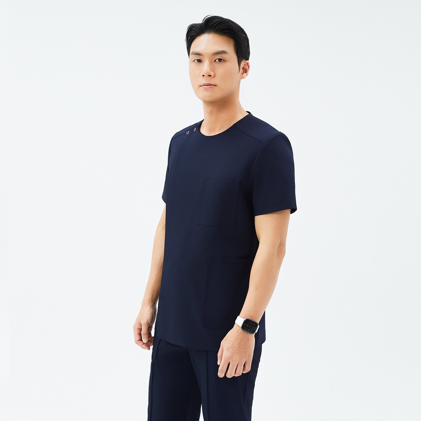 Image of Side angle of TUL DS-188 Eco Navy scrub top, highlighting the round snap neckline, tailored fit, and eco-friendly fabric.