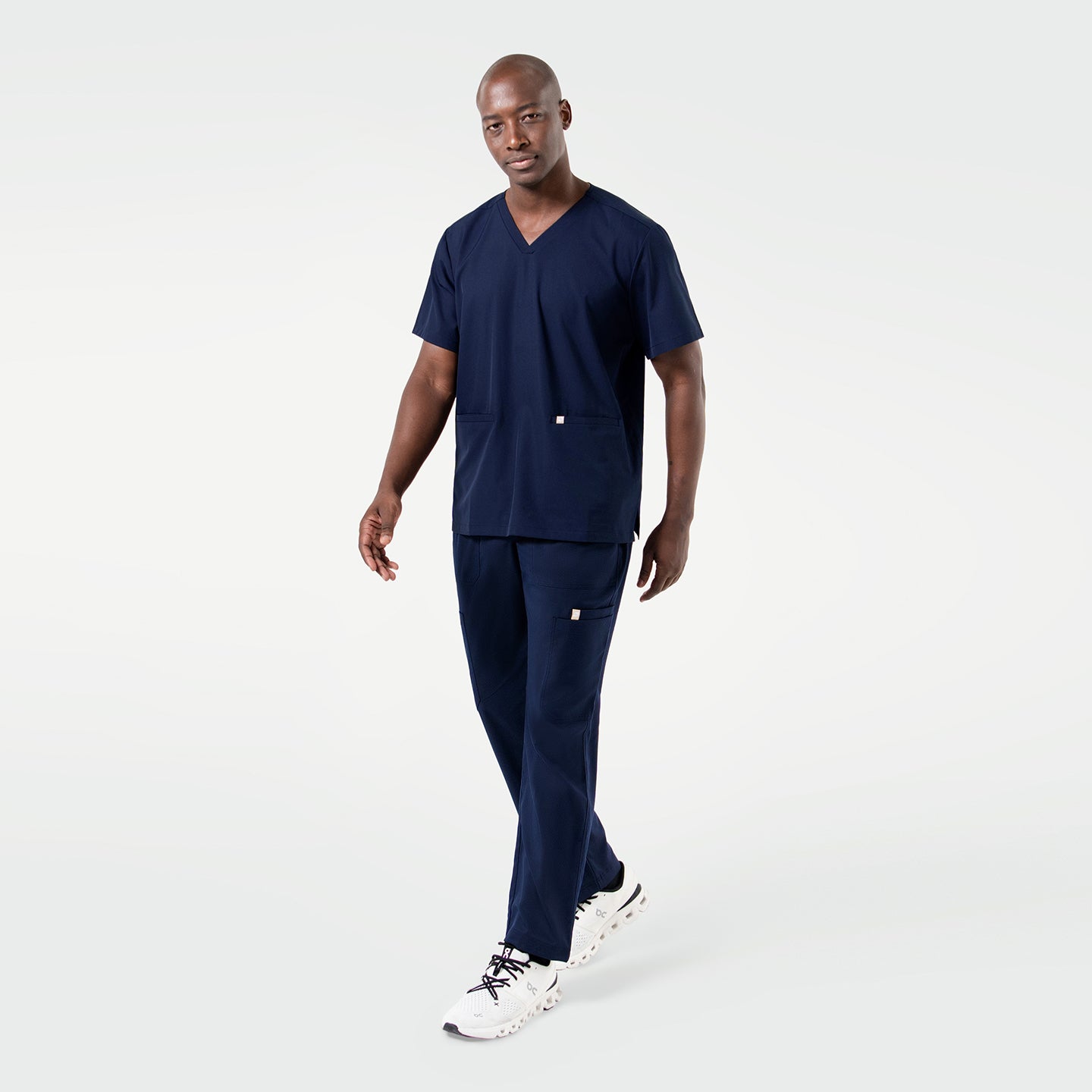 The Eco Navy Double Pocket Scrub Top features a deep navy tone and clean, contemporary lines.