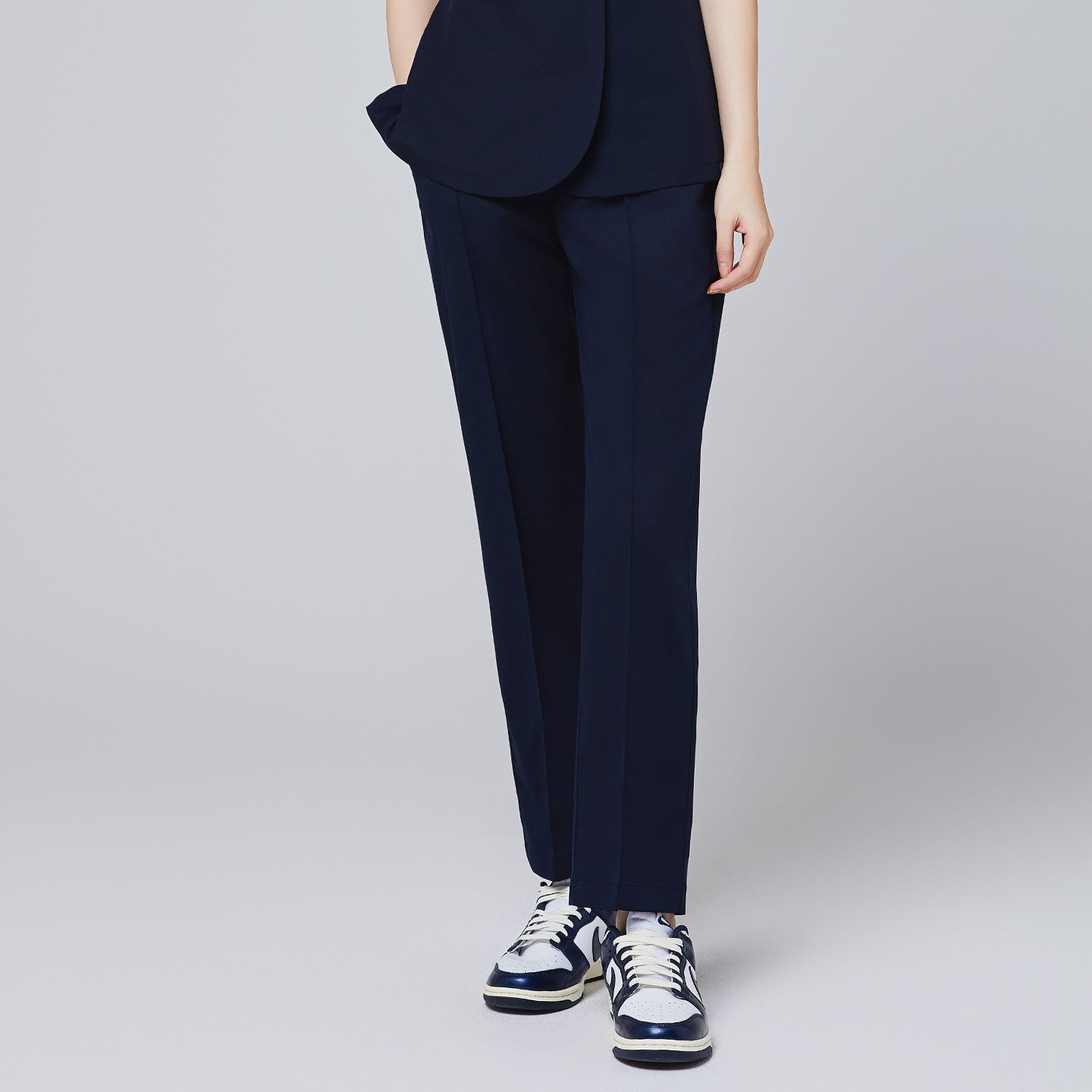 Eco navy banding scrub pants with a straight-leg fit, paired with white and navy sneakers for a professional look,Eco Navy