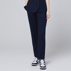 Image of Eco navy banding scrub pants with a straight-leg fit, paired with white and navy sneakers for a professional look,Eco Navy