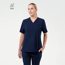 Image of A Female model wearing Eco Navy ZenFlex scrub top with matching scrub pants.