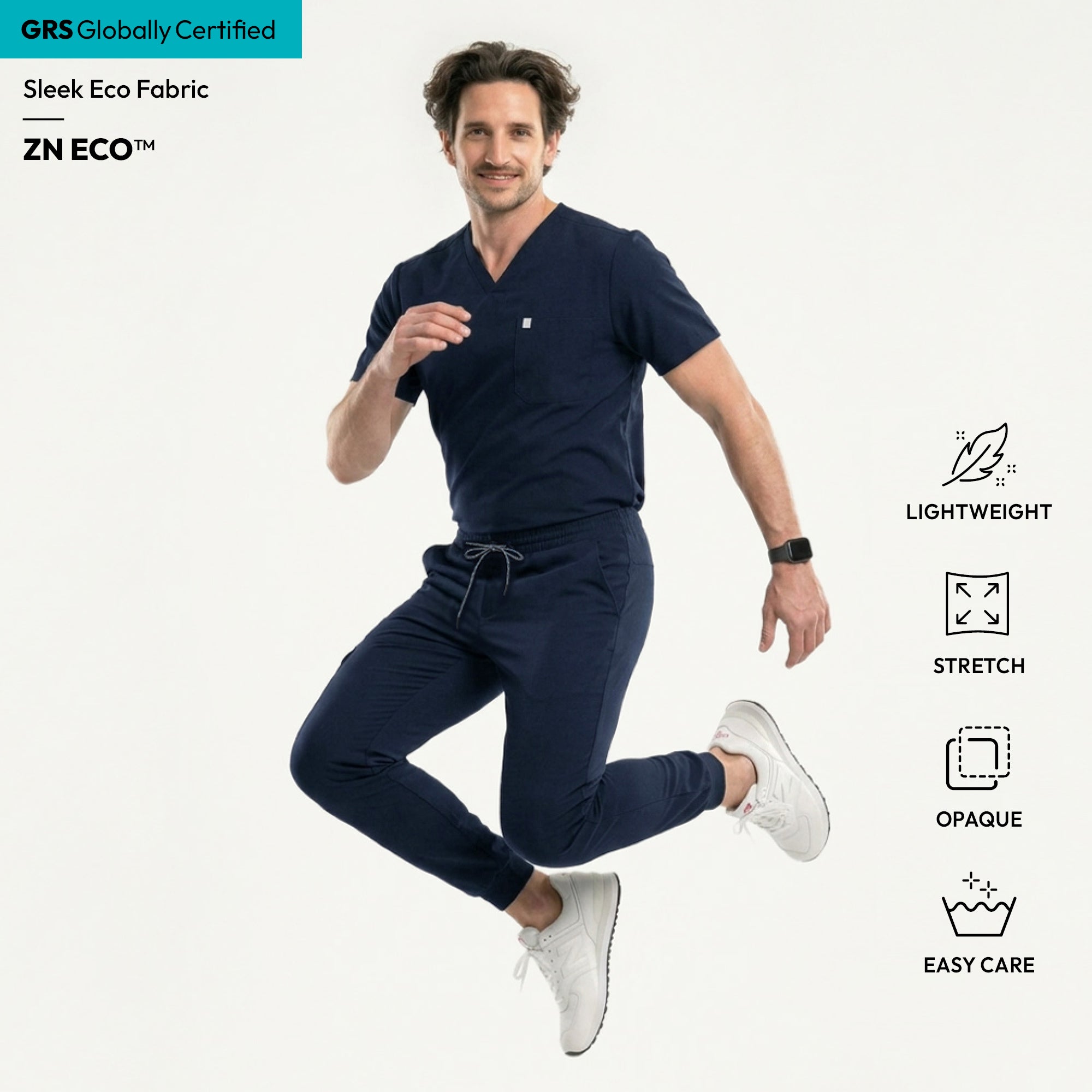 Image of Wearing the Eco Navy Single Pocket Scrub Top, the model takes a step with a relaxed, smiling expression.