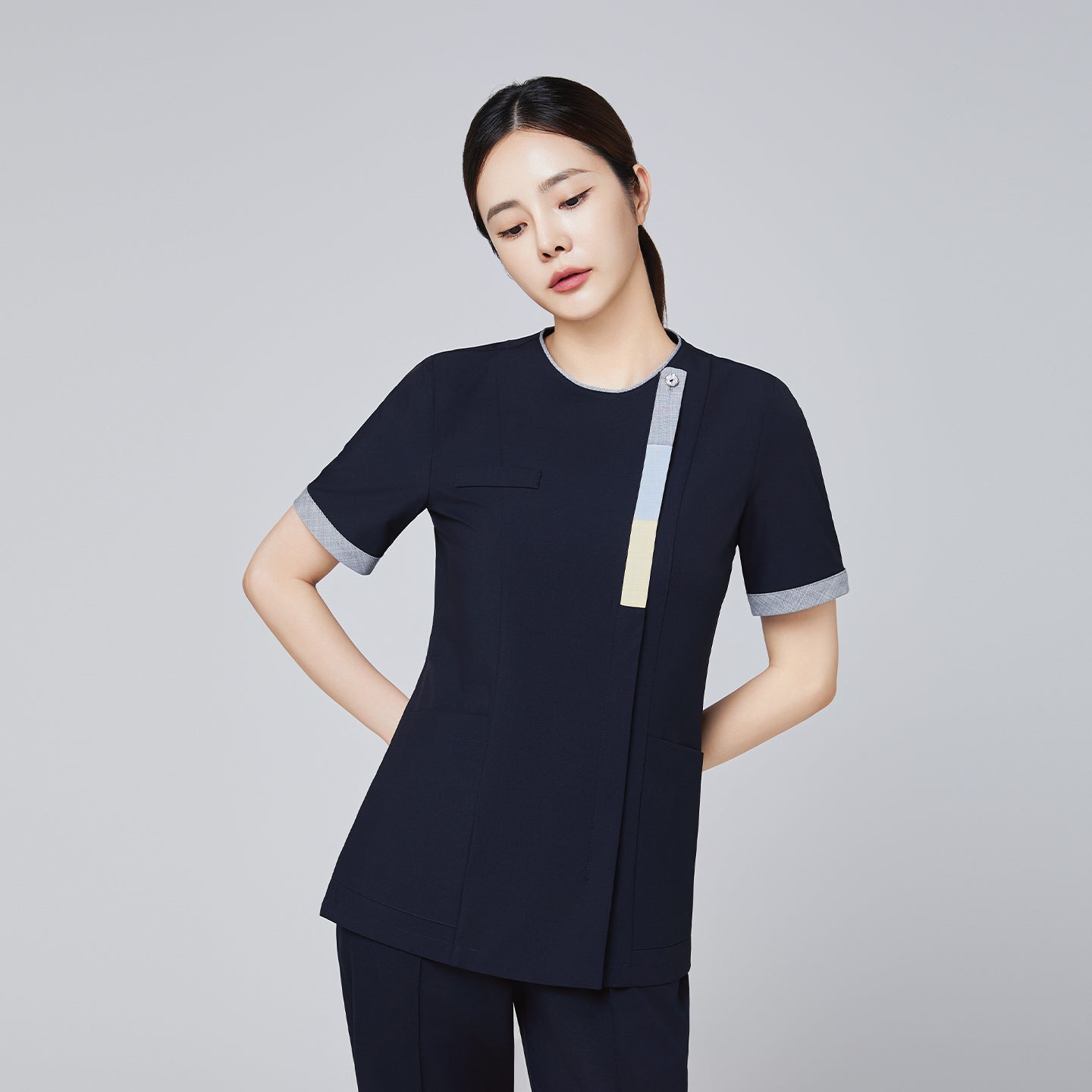 Image of Navy scrub top with short sleeves and triple-tone accents, featuring a front zipper and sleek professional design,Eco Navy