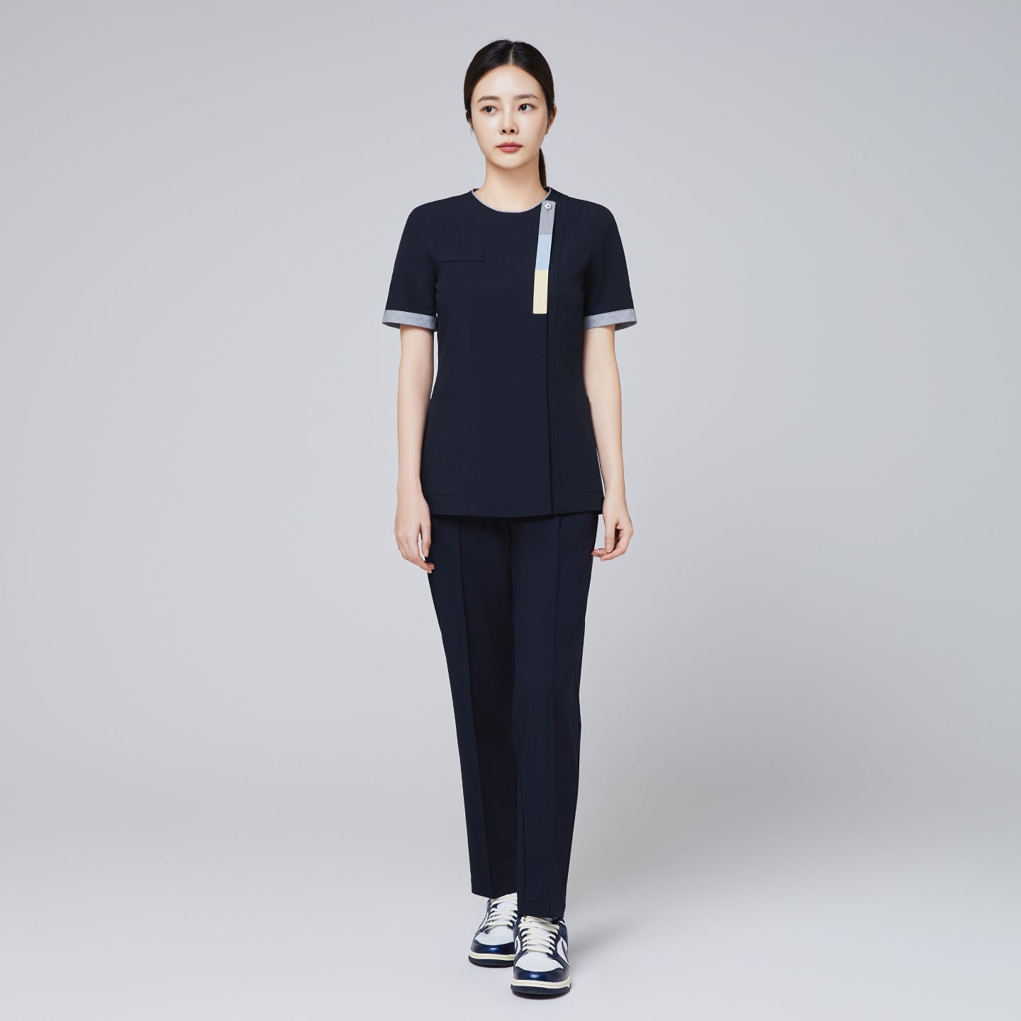 Image of Model wearing TUL Women's Premium Banding Pants in Eco Navy, highlighting a comfortable fit and polished front seams.