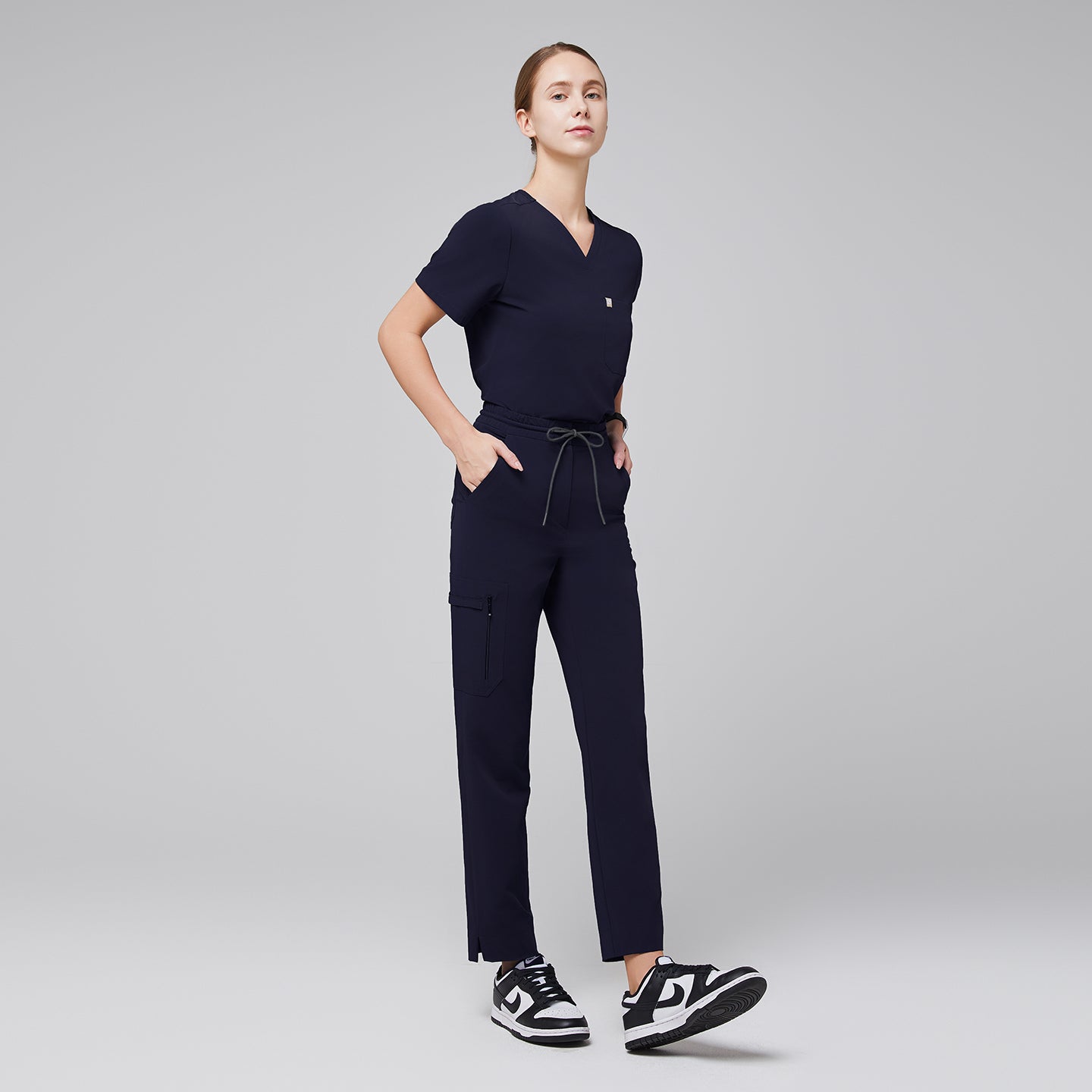 Image of Eco navy drawstring scrub pants Zenir featuring zipper thigh pocket and straight-leg fit, full-body.