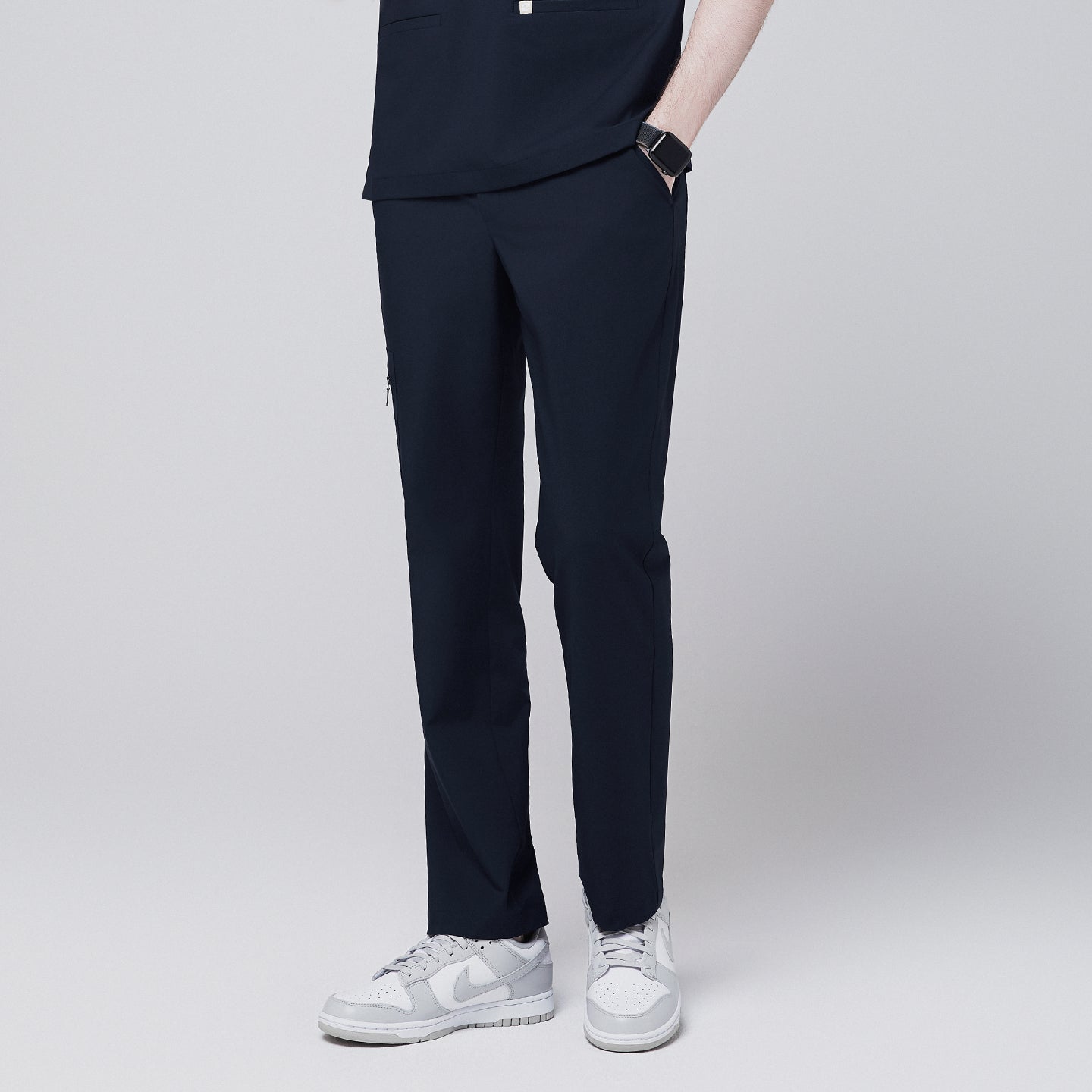 Image of Side view of navy straight scrub pants with a zipper pocket and relaxed fit,Eco Navy